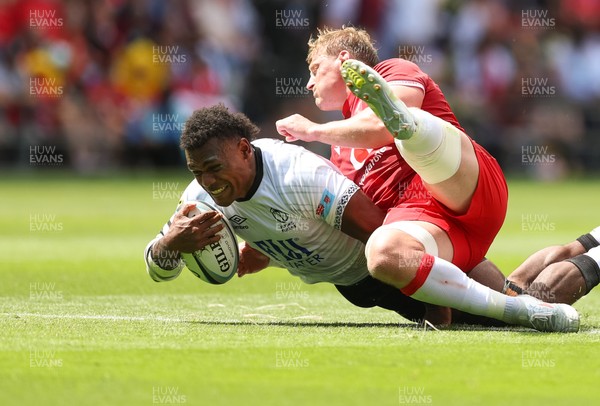 040726 - Fiji v Wales, Nations Championship - Elia Canakaivata of Fiji is tackled by Jac Morgan of Wales