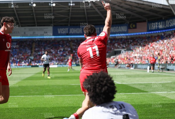 040726 - Fiji v Wales, Nations Championship - Josh Adams of Wales reaches between the legs of Selestino Ravutaumada of Fiji to score try