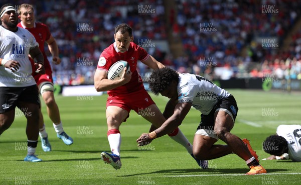 040726 - Fiji v Wales, Nations Championship - Tomos Williams of Wales is tackled just short of the line