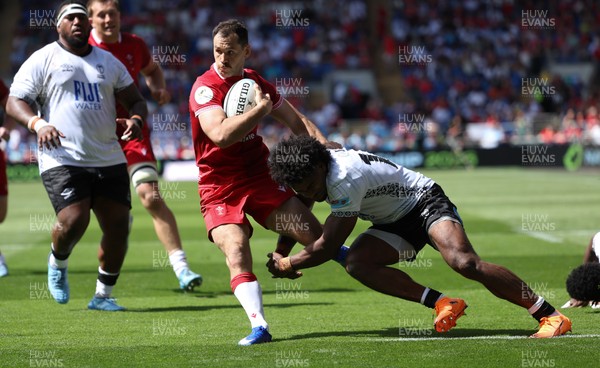 040726 - Fiji v Wales, Nations Championship - Tomos Williams of Wales is tackled just short of the line