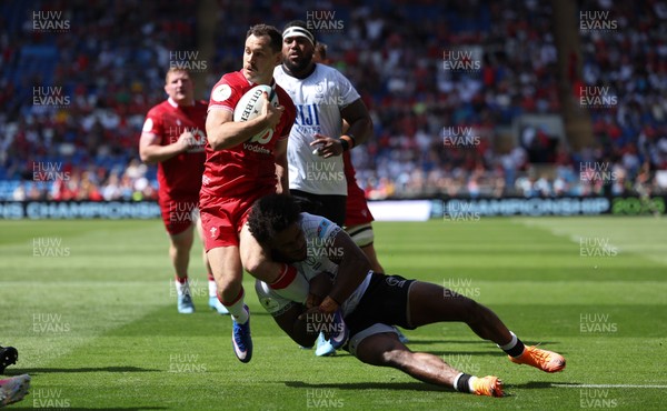 040726 - Fiji v Wales, Nations Championship - Tomos Williams of Wales is tackled just short of the line