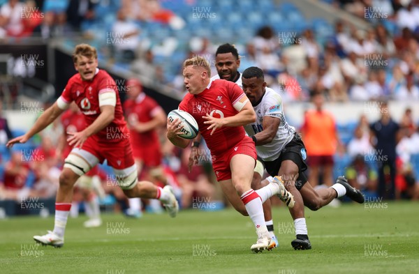 040726 - Fiji v Wales, Nations Championship - Sam Costelow of Wales breaks away