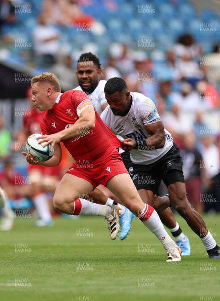 040726 - Fiji v Wales, Nations Championship - Sam Costelow of Wales breaks away