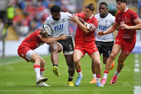 040726 - Fiji v Wales - Nations Championship - Kalaveti Ravouvou of Fiji is challenged by Josh Adams of Wales