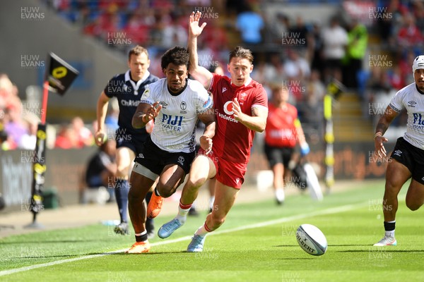 040726 - Fiji v Wales - Nations Championship - Josh Adams of Wales is challenged by Selestino Ravutaumada of Fiji