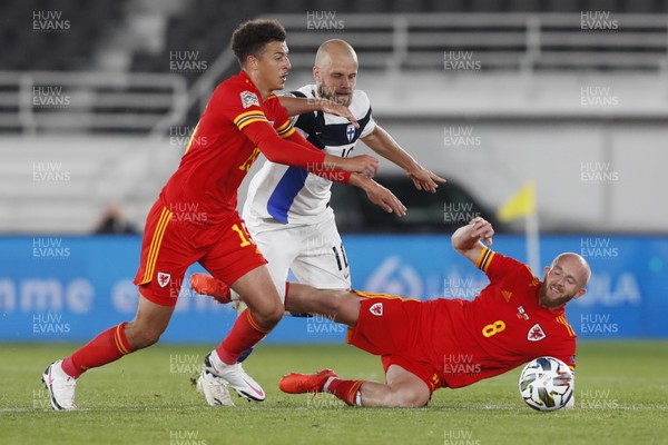 030920 - Finland v Wales - UEFA Nations League - Jonny Williams of Wales is tackled by Teemu Pukki of Finland as Ethan Ampadu (left) supports