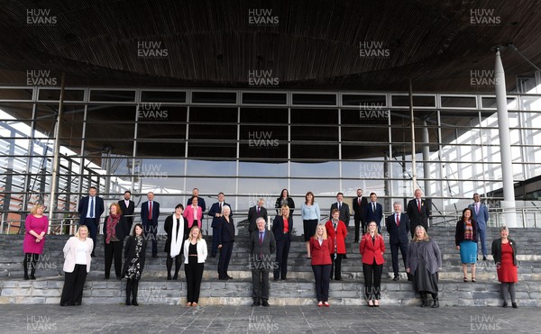 120521 - First Day of Welsh Parliament at the Senedd in Cardiff Bay - (L-R) Welsh Labour members of the Senedd Lynne Neagle MS, Rebecca Evans MS, Alun Davies MS, Julie Morgan MS, Hefin David MS, Buffy Williams MS, John Griffiths MS, Rhianon Passmore MS, Dawn Bowden MS, Jeremy Miles MS, Jayne Bryant MS, Mick Antoniw MS, Jenny Rathbone MS, Mike Hedges MS, Mark Drakeford MS, Carolyn Thomas MS, Vikki Howells MS, Lesley Griffiths MS, Hannah Blythyn MS, Joyce Watson MS, Lee Waters MS, Jack Sargeant MS, Sarah Murphy MS, Ken Skates MS, Huw Irranca-Davies MS, Julie James MS, David Rees MS, Eluned Morgan MS, Vaughan Gething MS and Jane Hutt MS during the first day of Welsh Parliament at the Senedd in Cardiff Bay