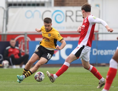 260425 - Fleetwood Town v Newport County - Sky Bet League 2 - Oliver Greaves of Newport is tackled by Mark Helm of Fleetwood