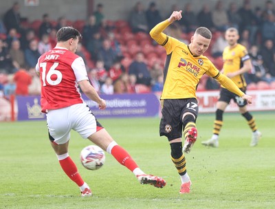 260425 - Fleetwood Town v Newport County - Sky Bet League 2 - Kieron Evans of Newport puts his shot through Mackenzie Hunt of Fleetwood