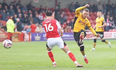 260425 - Fleetwood Town v Newport County - Sky Bet League 2 - Kieron Evans of Newport puts his shot through Mackenzie Hunt of Fleetwood