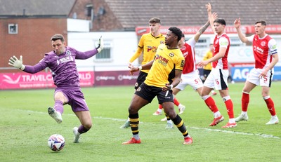 260425 - Fleetwood Town v Newport County - Sky Bet League 2 - Goalkeeper Jay Lynch of Fleetwood stops a shot on goal by Bobby Kamwa of Newport