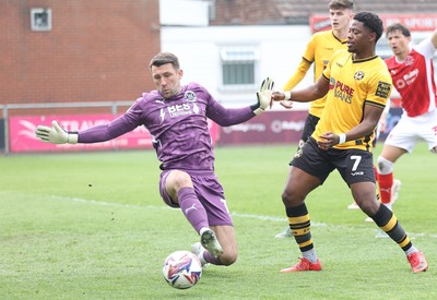 260425 - Fleetwood Town v Newport County - Sky Bet League 2 - Goalkeeper Jay Lynch of Fleetwood stops a shot on goal by Bobby Kamwa of Newport