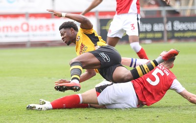 260425 - Fleetwood Town v Newport County - Sky Bet League 2 - Bobby Kamwa of Newport is sandwiched between James Bolton of Fleetwood and Will Johnson of Fleetwood and is brought down by James Bolton of Fleetwood