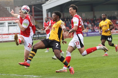 260425 - Fleetwood Town v Newport County - Sky Bet League 2 - Bobby Kamwa of Newport is sandwiched between  Will Johnson of Fleetwood and Ryan Broom of Fleetwood as he shoots for goal