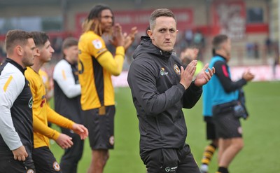 260425 - Fleetwood Town v Newport County - Sky Bet League 2 - Newport team led by Newport caretaker manager Dafydd Williams applaud the travelling fans at the end of the game