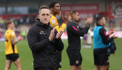 260425 - Fleetwood Town v Newport County - Sky Bet League 2 - Newport team led by Newport caretaker manager Dafydd Williams applaud the travelling fans at the end of the game