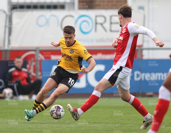 260425 - Fleetwood Town v Newport County - Sky Bet League 2 - Oliver Greaves of Newport is tackled by Mark Helm of Fleetwood