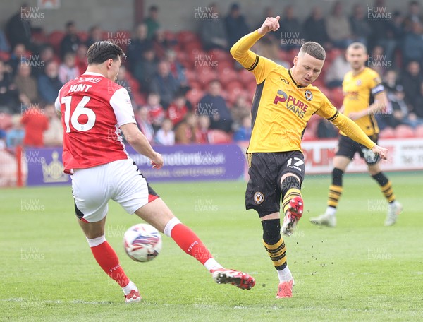 260425 - Fleetwood Town v Newport County - Sky Bet League 2 - Kieron Evans of Newport puts his shot through Mackenzie Hunt of Fleetwood