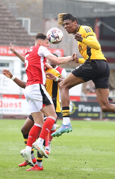 260425 - Fleetwood Town v Newport County - Sky Bet League 2 - Kyle Hudlin of Newport clears the high ball with James Bolton of Fleetwood