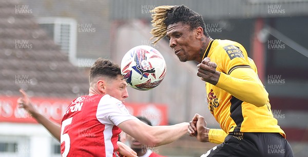 260425 - Fleetwood Town v Newport County - Sky Bet League 2 - Kyle Hudlin of Newport clears the high ball with James Bolton of Fleetwood