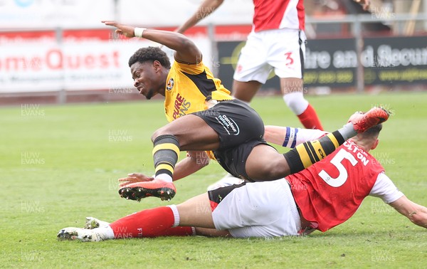 260425 - Fleetwood Town v Newport County - Sky Bet League 2 - Bobby Kamwa of Newport is sandwiched between James Bolton of Fleetwood and Will Johnson of Fleetwood and is brought down by James Bolton of Fleetwood