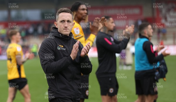 260425 - Fleetwood Town v Newport County - Sky Bet League 2 - Newport team led by Newport caretaker manager Dafydd Williams applaud the travelling fans at the end of the game