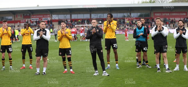 260425 - Fleetwood Town v Newport County - Sky Bet League 2 - Newport team led by Newport caretaker manager Dafydd Williams applaud the travelling fans at the end of the game