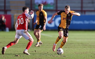 280226 - Fleetwood Town v Newport County - Sky Bet League 2 - Sven Sprangler of Newport makes his way up the field followed by Mark Helm of Fleetwood