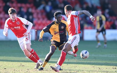 280226 - Fleetwood Town v Newport County - Sky Bet League 2 - Nathan Opoku of Newport tries to out do Elliot Bonds of Fleetwood and Conor Hughes of Fleetwood