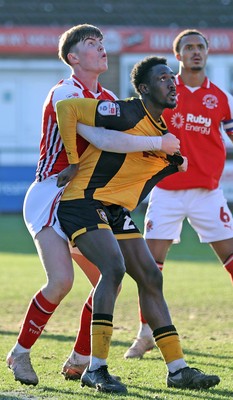 280226 - Fleetwood Town v Newport County - Sky Bet League 2 - Nathan Opoku of Newport is held by Conor Houghey of Fleetwood
