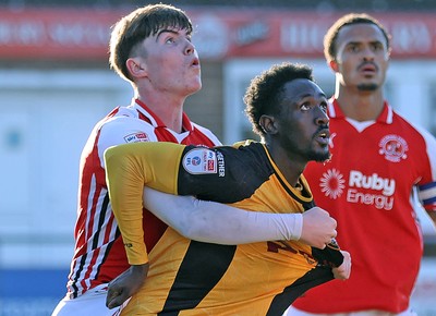 280226 - Fleetwood Town v Newport County - Sky Bet League 2 - Nathan Opoku of Newport is held by Conor Houghey of Fleetwood