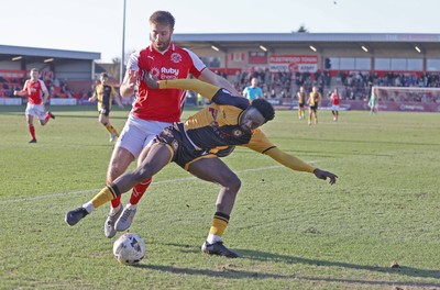 280226 - Fleetwood Town v Newport County - Sky Bet League 2 - Nathan Opoku of Newport and Shaun Rooney of Fleetwood