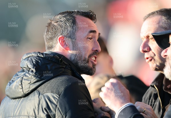 280226 - Fleetwood Town v Newport County - Sky Bet League 2 - Newport manager Christian Fuchs joins the travelling fans at the end of the match