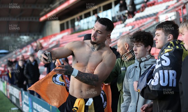 280226 - Fleetwood Town v Newport County - Sky Bet League 2 - Courtney Baker-Richardson of Newport with fans taking selfies