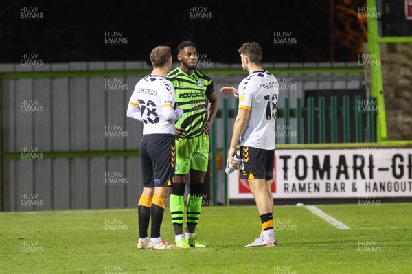 011220 - Forest Green Rovers v Newport County - Sky Bet League 2 - Jamille Matt of Forest Green catches up with Mickey Demetriou of Newport County and Jamie Proctor of Newport County