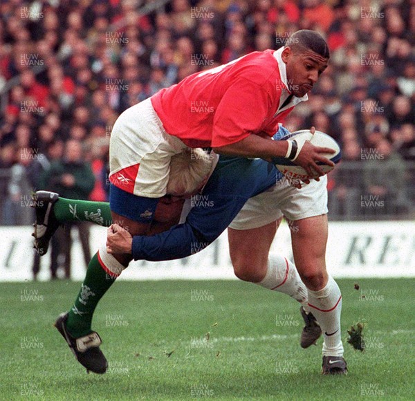 060399 - France v Wales - Five Nations -   Matthew Robinson of Wales is tackled by Thomas Castaignede 