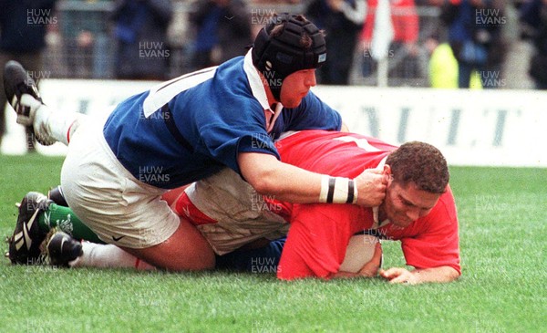 060399 - France v Wales - Five Nations - Peter Rogers is tackled