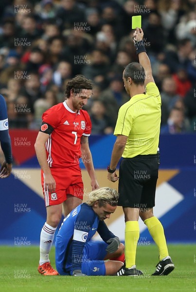 101117 - France v Wales - International Friendly - Joe Allen of Wales is given a yellow card for his tackle on Antoine Griezmann of France