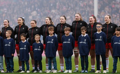 120425 - France v Wales, Guinness Women’s Six Nations 2025 -Nel Metcalfe, Bryonie King, Jenni Scoble, Gwen Crabb, Maisie Davies, Alaw Prys, Gwenllian Pyrs and Carys Cox of Wales line up for the anthem