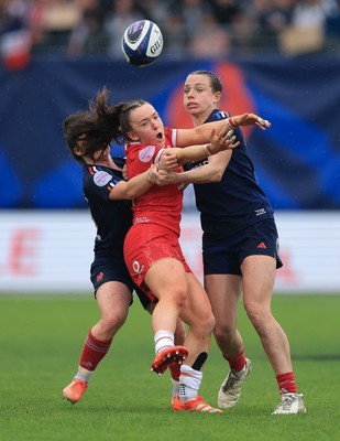120425 - France v Wales, Guinness Women’s Six Nations 2025 - Sian Jones of Wales is held by Oceane Bordes of France and Marine Menager of France