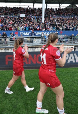 120425 - France v Wales, Guinness Women’s Six Nations 2025 - Carys Cox of Wales and Kayleigh Powell of Wales applaud the French supporters at the end of the match