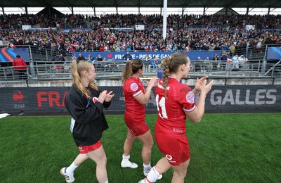 120425 - France v Wales, Guinness Women’s Six Nations 2025 - Cath Richards, Carys Cox of Wales and Kayleigh Powell of Wales applaud the French supporters at the end of the match