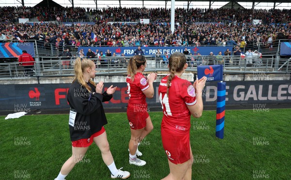 120425 - France v Wales, Guinness Women’s Six Nations 2025 - Cath Richards, Courtney Keight of Wales and Carys Cox of Wales applaud the French supporters at the end of the match