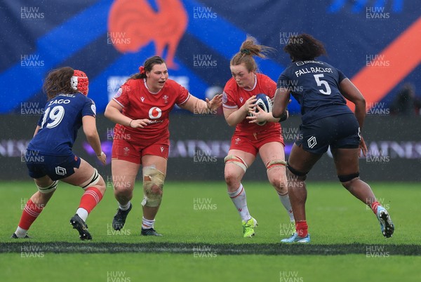 120425 - France v Wales, Guinness Women’s Six Nations 2025 - Abbie Fleming of Wales with Gwenllian Pyrs of Wales in support takes on Kiara Zago of France and Madouddou Fall-Raclot of France