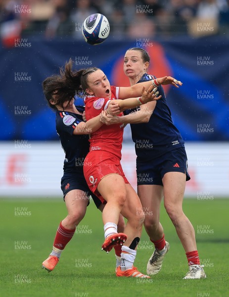 120425 - France v Wales, Guinness Women’s Six Nations 2025 - Sian Jones of Wales is held by Oceane Bordes of France and Marine Menager of France