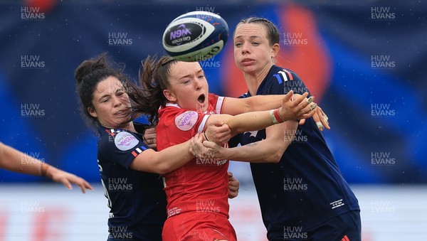 120425 - France v Wales, Guinness Women’s Six Nations 2025 - Sian Jones of Wales is held by Oceane Bordes of France and Marine Menager of France