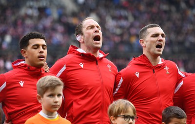 180323 - France v Wales - Guinness Six Nations - Rio Dyer, Alun Wyn Jones and George North of Wales sing the anthem