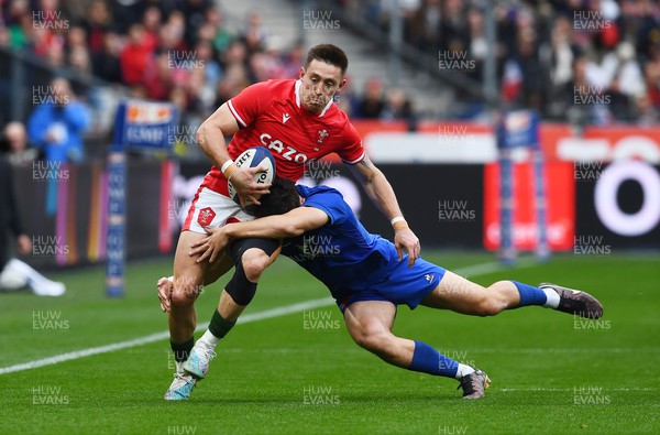 180323 - France v Wales - Guinness Six Nations - Josh Adams of Wales is tackled by Ethan Dumortier of France 