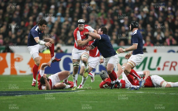 19.03.11 France v Wales ... Wales Ryan Jones is tackled by France's Thomas Domingo. 