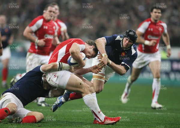 19.03.11 France v Wales ... Wales George North is tackled by France's Julien Bonnaire and France's Damien Traille. 